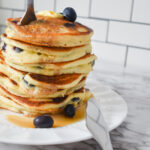 Lemon blueberry pancake stack with fork and knife