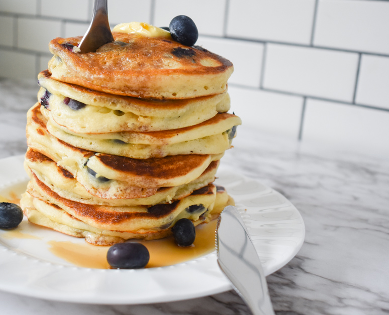 Lemon blueberry pancake stack with fork and knife