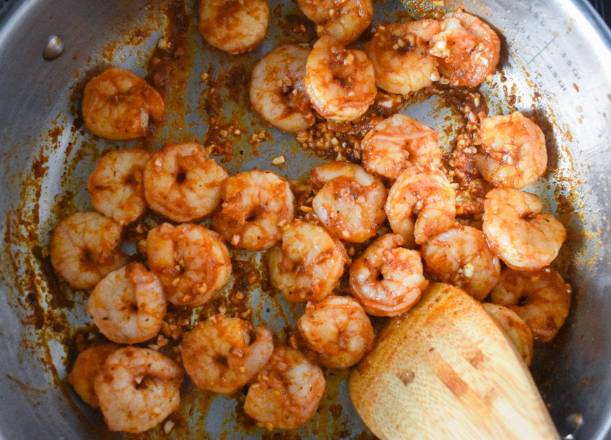 Seasoned shrimp cooking in pan